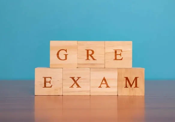 concept-of-gre-exam-in-wooden-block-letters-on-table